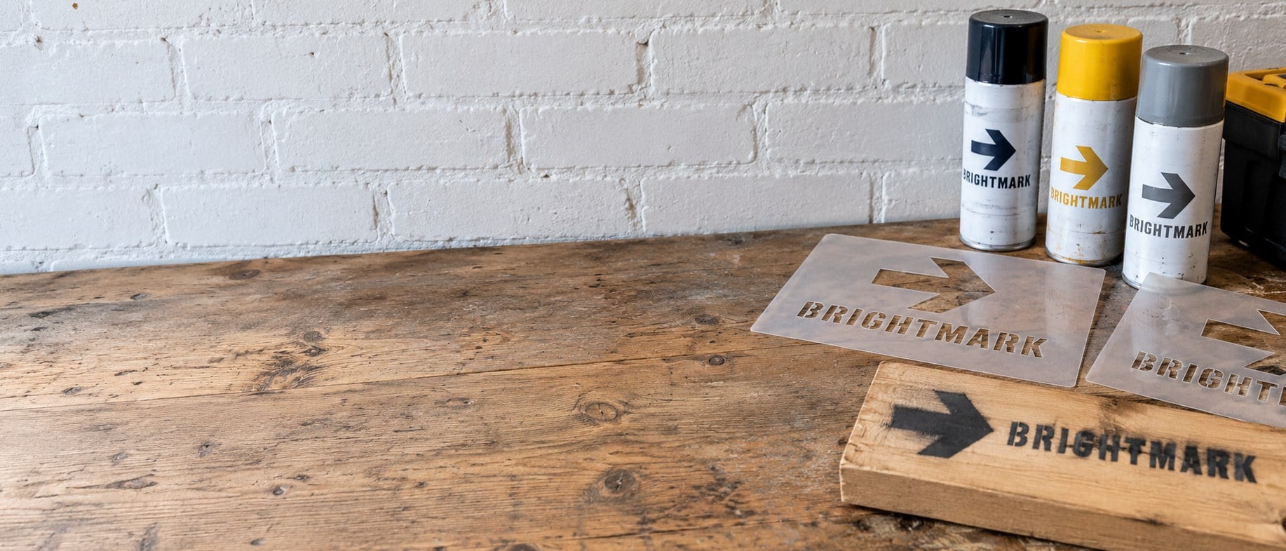 Custom laser-cut logo stencils in bulk laid out on a workbench